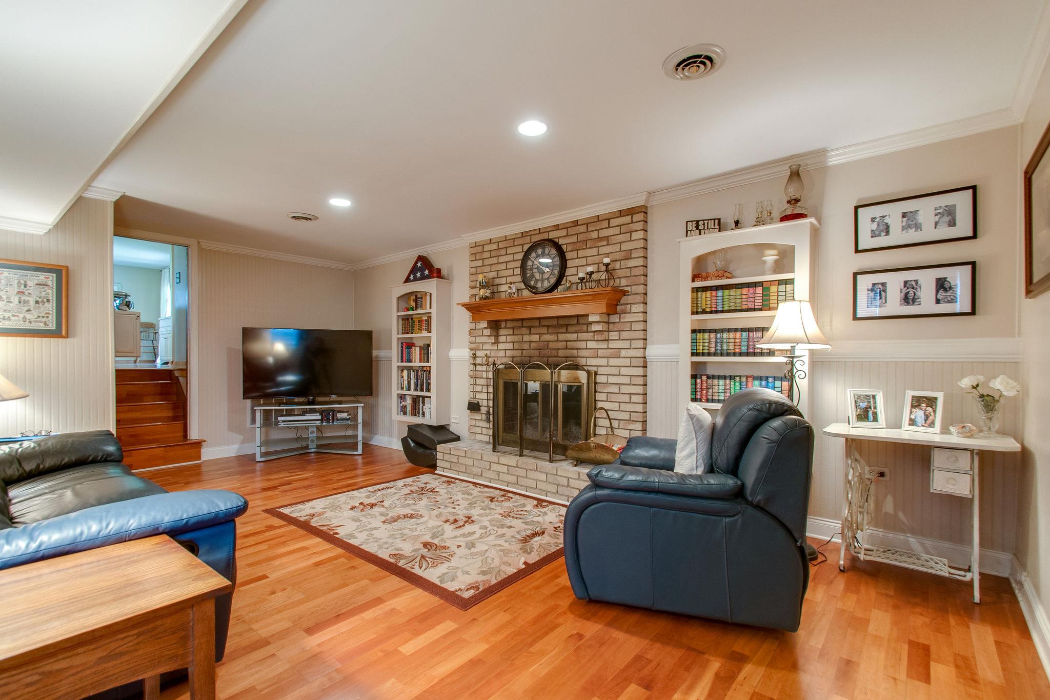 9576 Mullens Road Arrington, TN 37014 - Photo 12 of 26 a living room with furniture flat screen tv and a fireplace