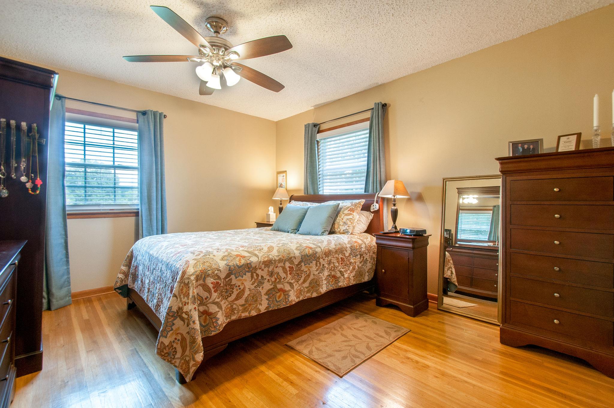 9576 Mullens Road Arrington, TN 37014 - Photo 15 of 26 a bedroom with a bed and wooden floor