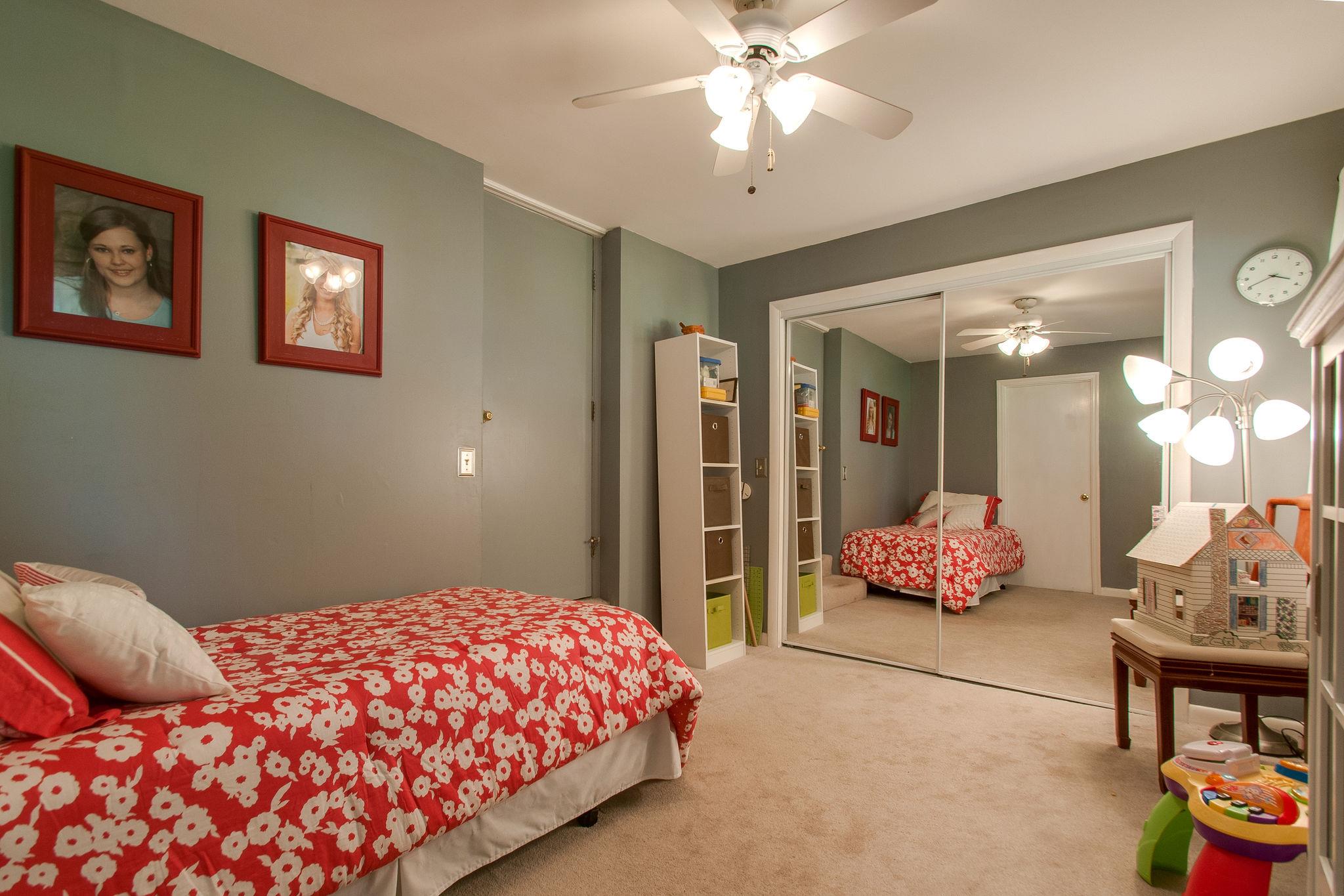 9576 Mullens Road Arrington, TN 37014 - Photo 18 of 26 a bedroom with a bed mirror and painting on the wall