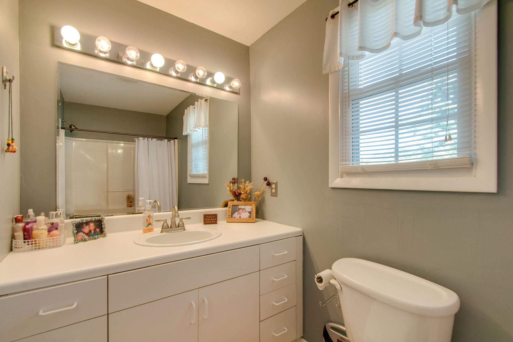 9576 Mullens Road Arrington, TN 37014 - Photo 19 of 26 a bathroom with a sink mirror and toilet