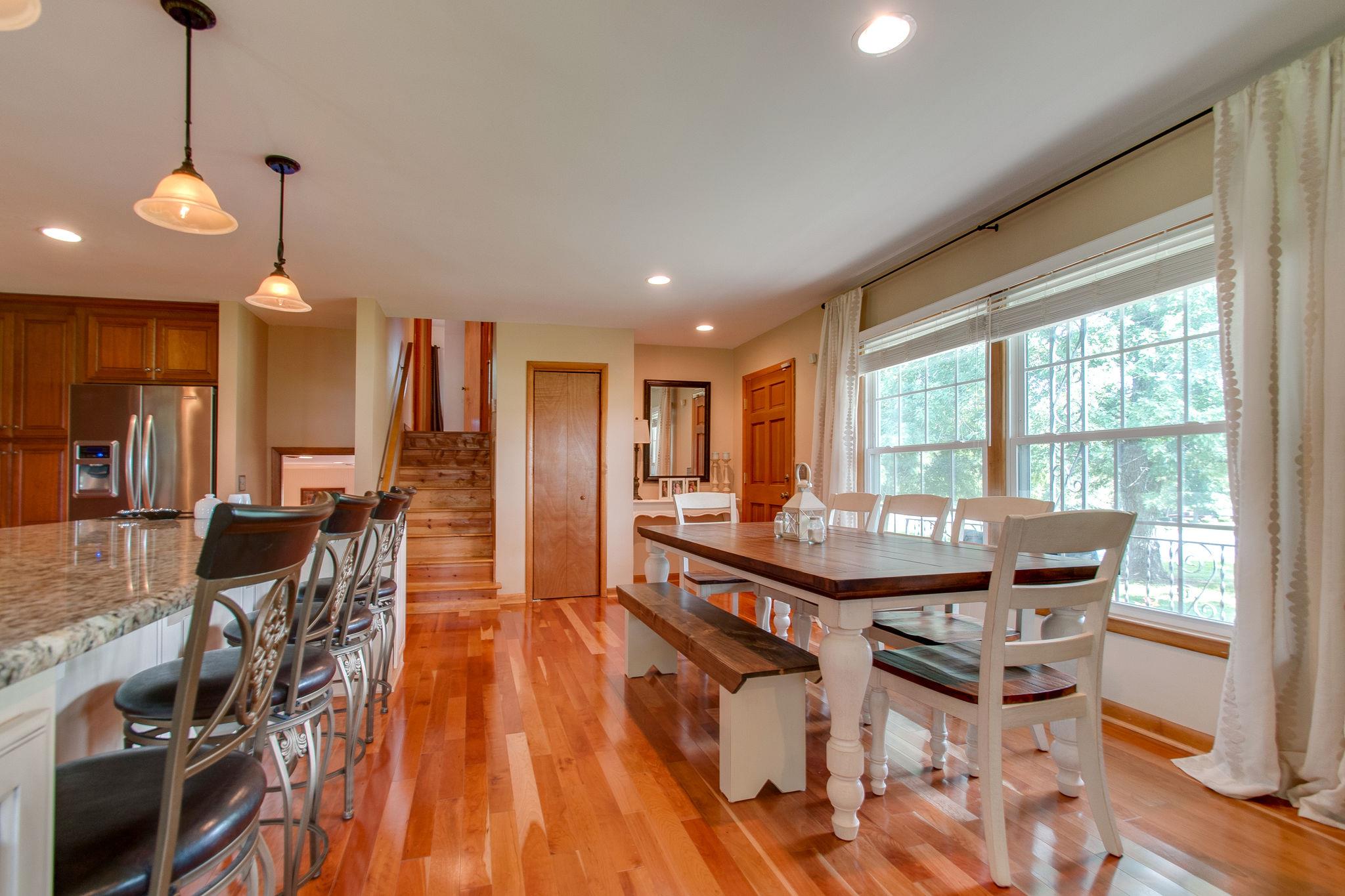9576 Mullens Road Arrington, TN 37014 - Photo 4 of 26 a view of a dining room with furniture and wooden floor
