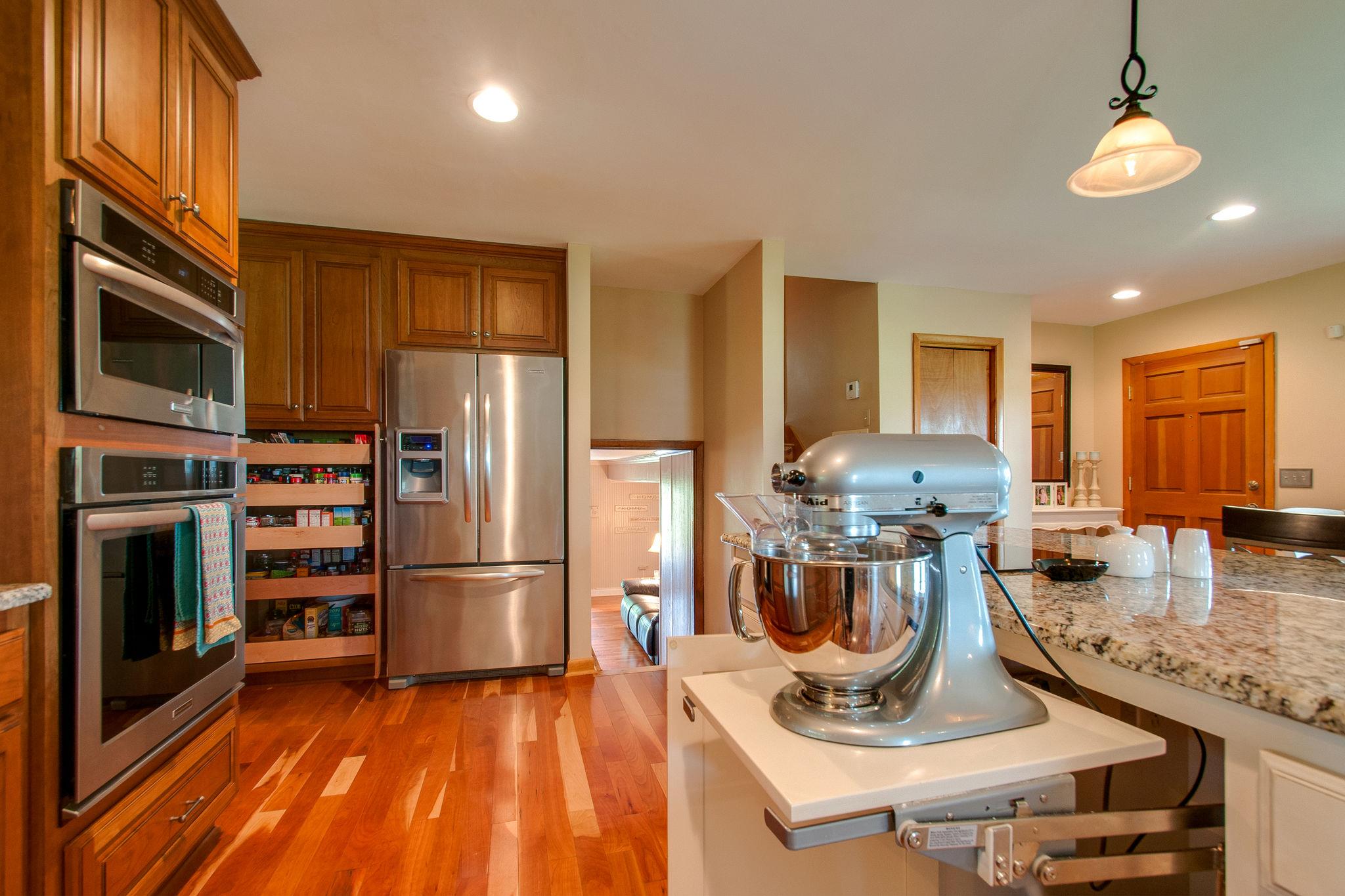 9576 Mullens Road Arrington, TN 37014 - Photo 8 of 26 a kitchen with a refrigerator and a stove top oven
