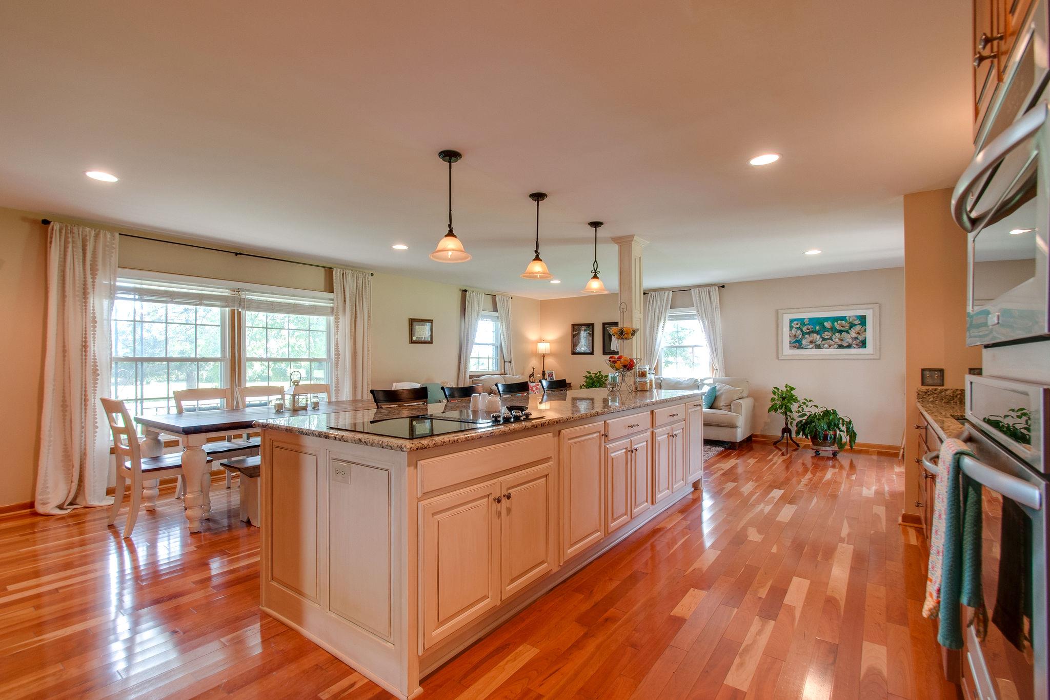 9576 Mullens Road Arrington, TN 37014 - Photo 10 of 26 a kitchen with stainless steel appliances granite countertop a stove and a wooden floors