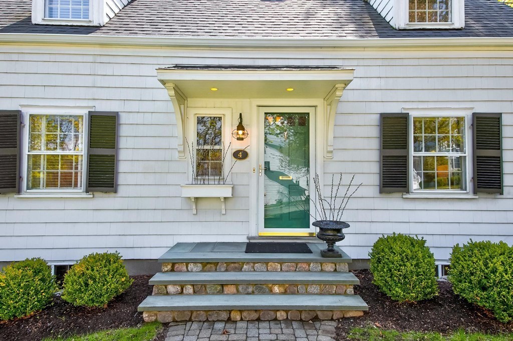 4 Pine Hill Circle Wakefield, MA 01880 - Photo 4 of 41 a front view of a house with a garden and plants