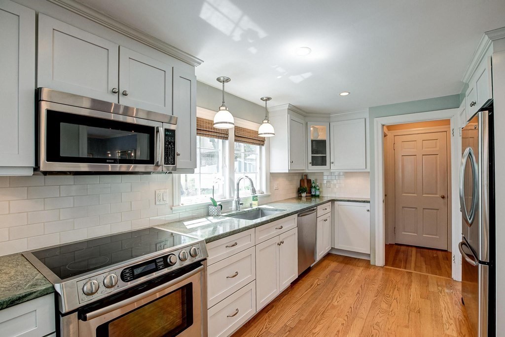 4 Pine Hill Circle Wakefield, MA 01880 - Photo 7 of 41 a kitchen with stainless steel appliances a stove microwave and sink