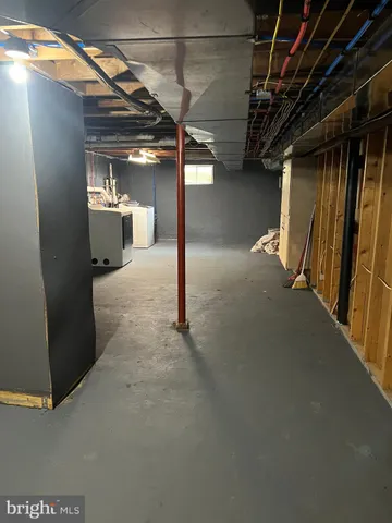 a view of empty room with window and wooden floor