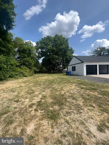 a view of house with yard and island in front of it
