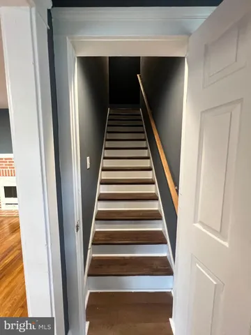 a view of a room with wooden floor and a window