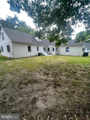 a front view of house with yard and trees