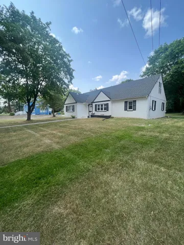 a big room with yard and trees in the background