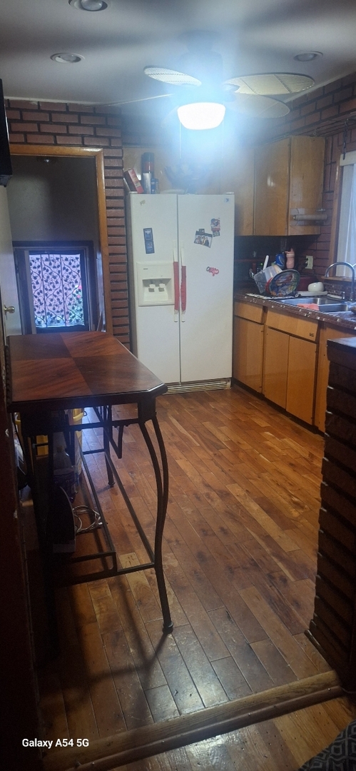 9351 South Normal Avenue Chicago, IL 60620 - Photo 8 of 14 a kitchen with kitchen island a stove and a refrigerator