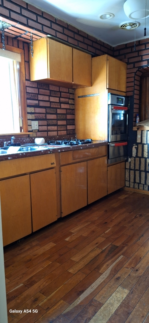 9351 South Normal Avenue Chicago, IL 60620 - Photo 9 of 14 a kitchen with stainless steel appliances granite countertop a sink and cabinets