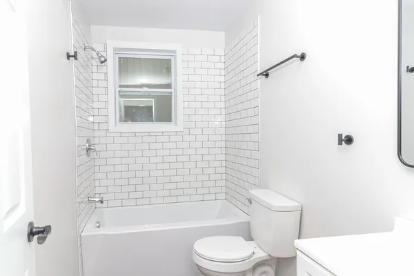 a bathroom with a toilet and shower