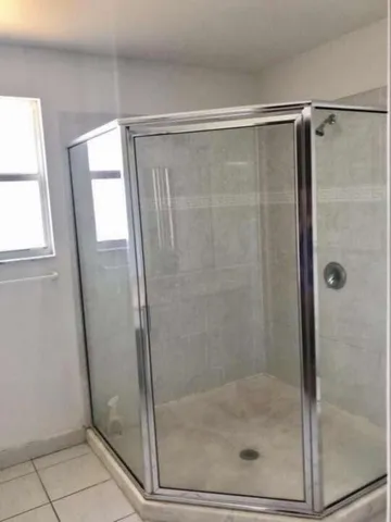 a bathroom with a glass shower door