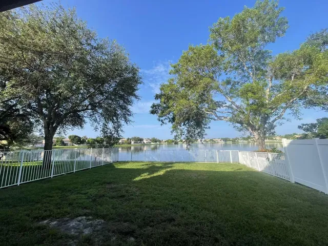 a view of yard with grass and trees