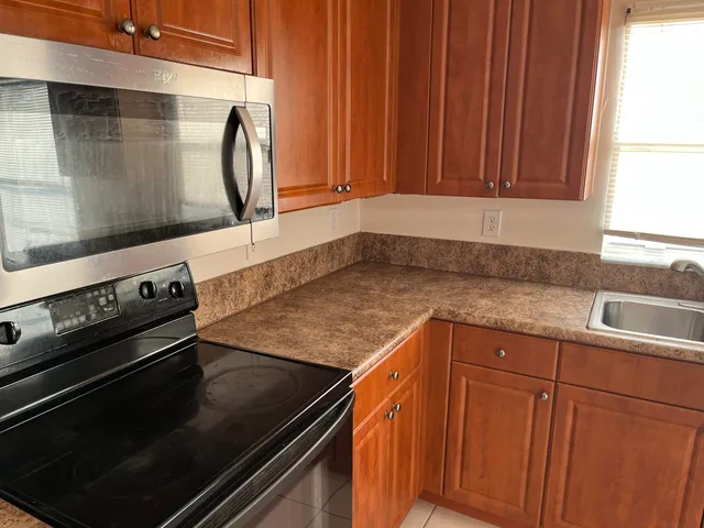 a kitchen with wooden cabinets and a stove top oven