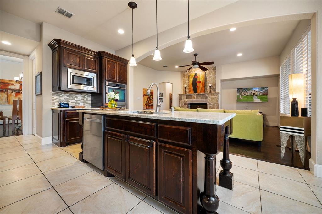 2114 Spicewood Drive Allen, TX 75013 - Photo 37 of 37 a kitchen with a sink counter top space appliances and a center island