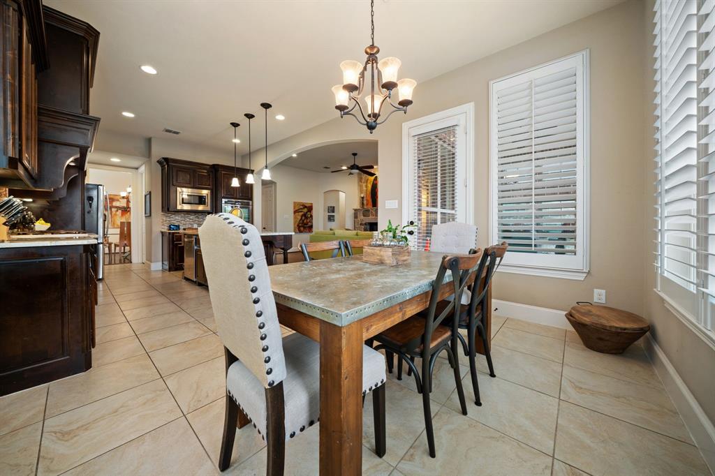 2114 Spicewood Drive Allen, TX 75013 - Photo 12 of 37 a dining hall with stainless steel appliances kitchen island granite countertop a dining table chairs and a large window