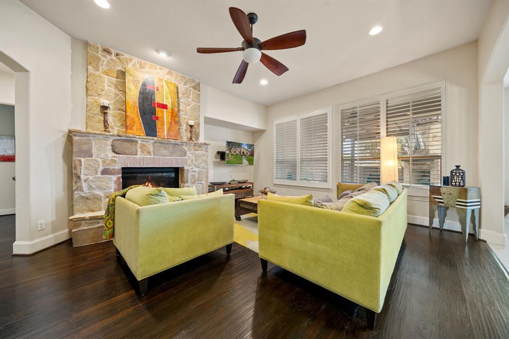 2114 Spicewood Drive Allen, TX 75013 - Photo 13 of 37 a living room with furniture and a fireplace