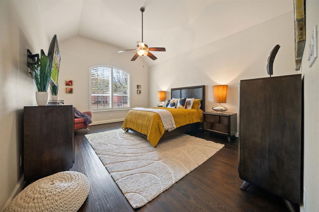 2114 Spicewood Drive Allen, TX 75013 - Photo 17 of 37 Bedroom featuring dark wood-style floors, vaulted ceiling, and a ceiling fan