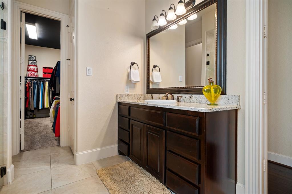2114 Spicewood Drive Allen, TX 75013 - Photo 20 of 37 a bathroom with a sink and a mirror