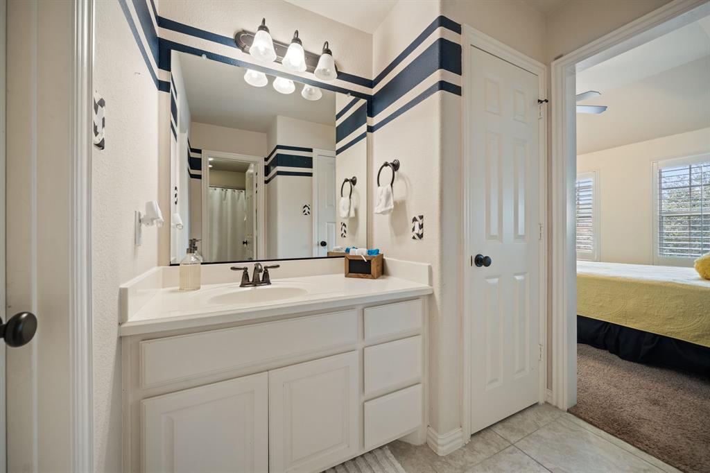 2114 Spicewood Drive Allen, TX 75013 - Photo 28 of 37 a bathroom with a double vanity sink mirror and a bathtub