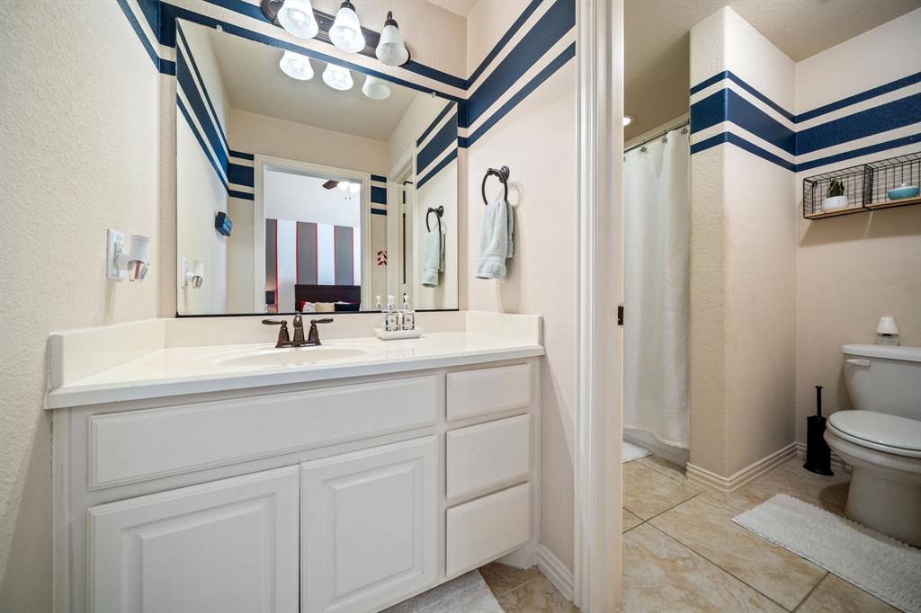 2114 Spicewood Drive Allen, TX 75013 - Photo 29 of 37 a bathroom with a sink and a mirror