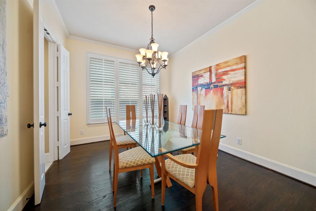 2114 Spicewood Drive Allen, TX 75013 - Photo 7 of 37 a dining room with furniture a chandelier and wooden floor