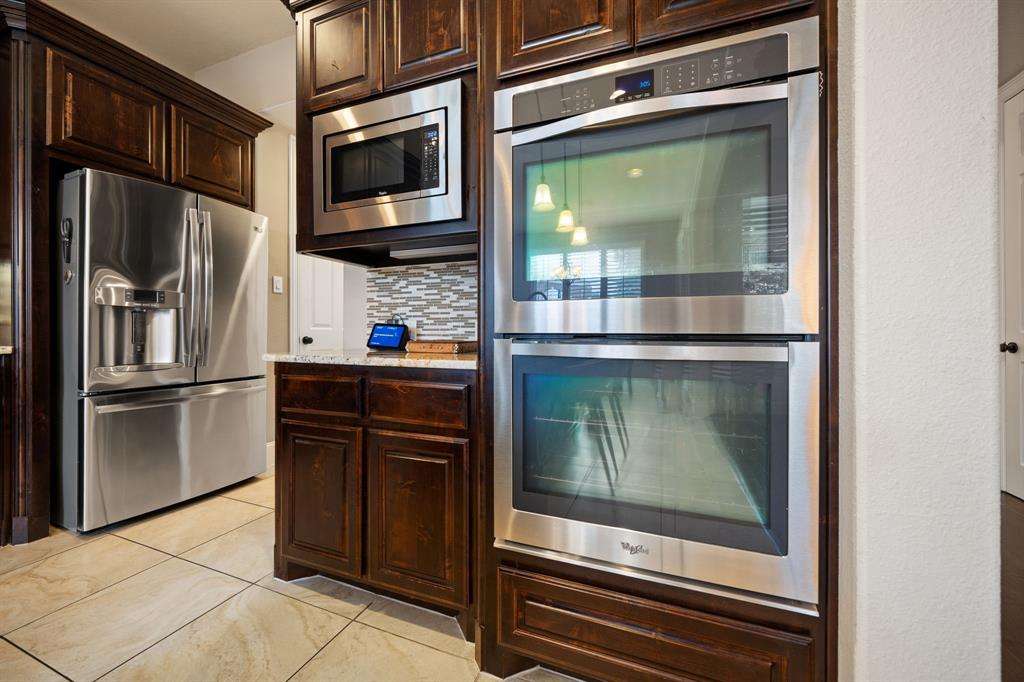 2114 Spicewood Drive Allen, TX 75013 - Photo 9 of 37 a kitchen with a refrigerator and a microwave