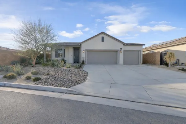 a view of a house with a yard and garage