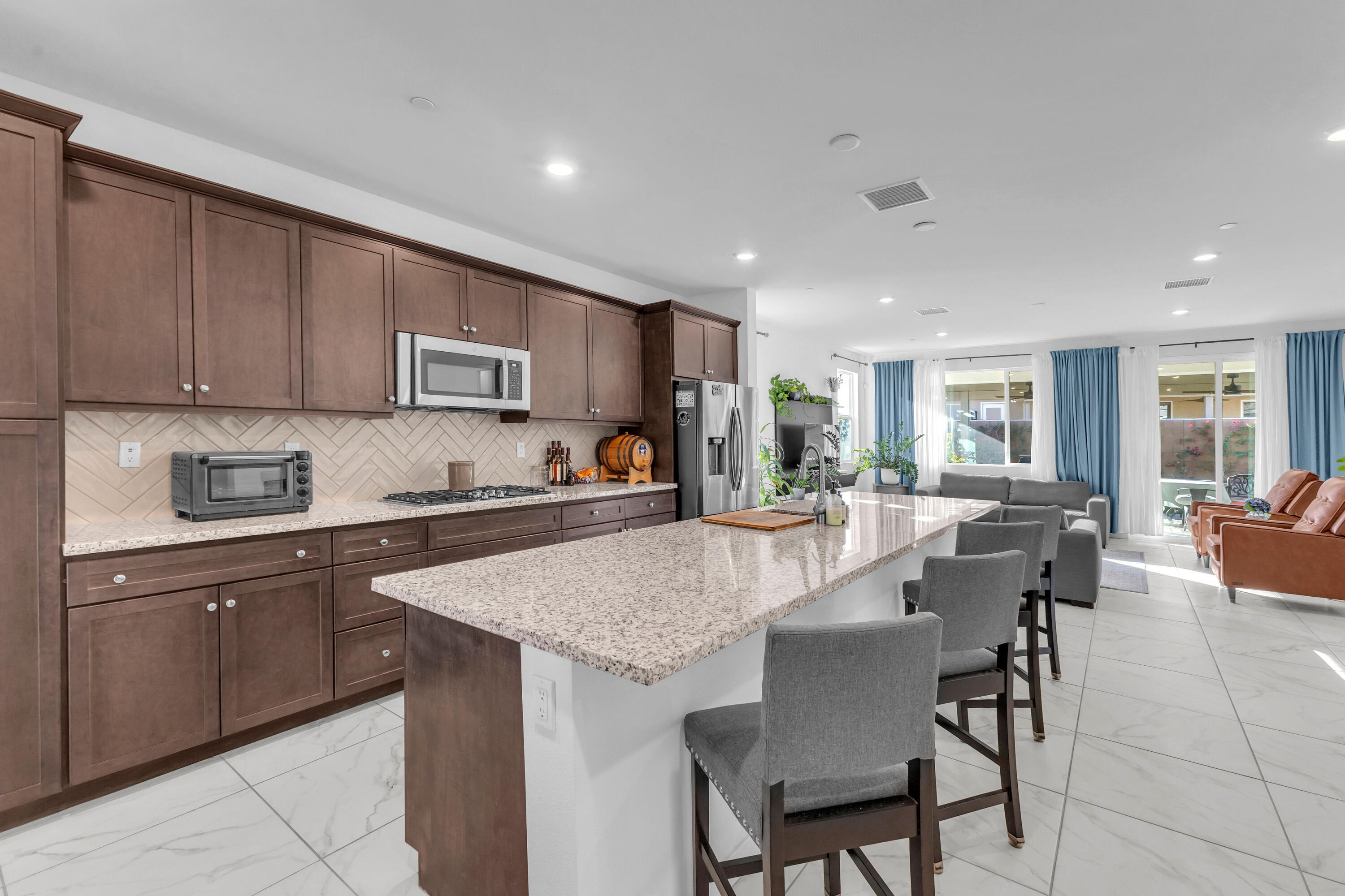 39763 Majorca Drive South Indio, CA 92203 - Photo 11 of 57 a kitchen with a dining table chairs and wooden cabinets
