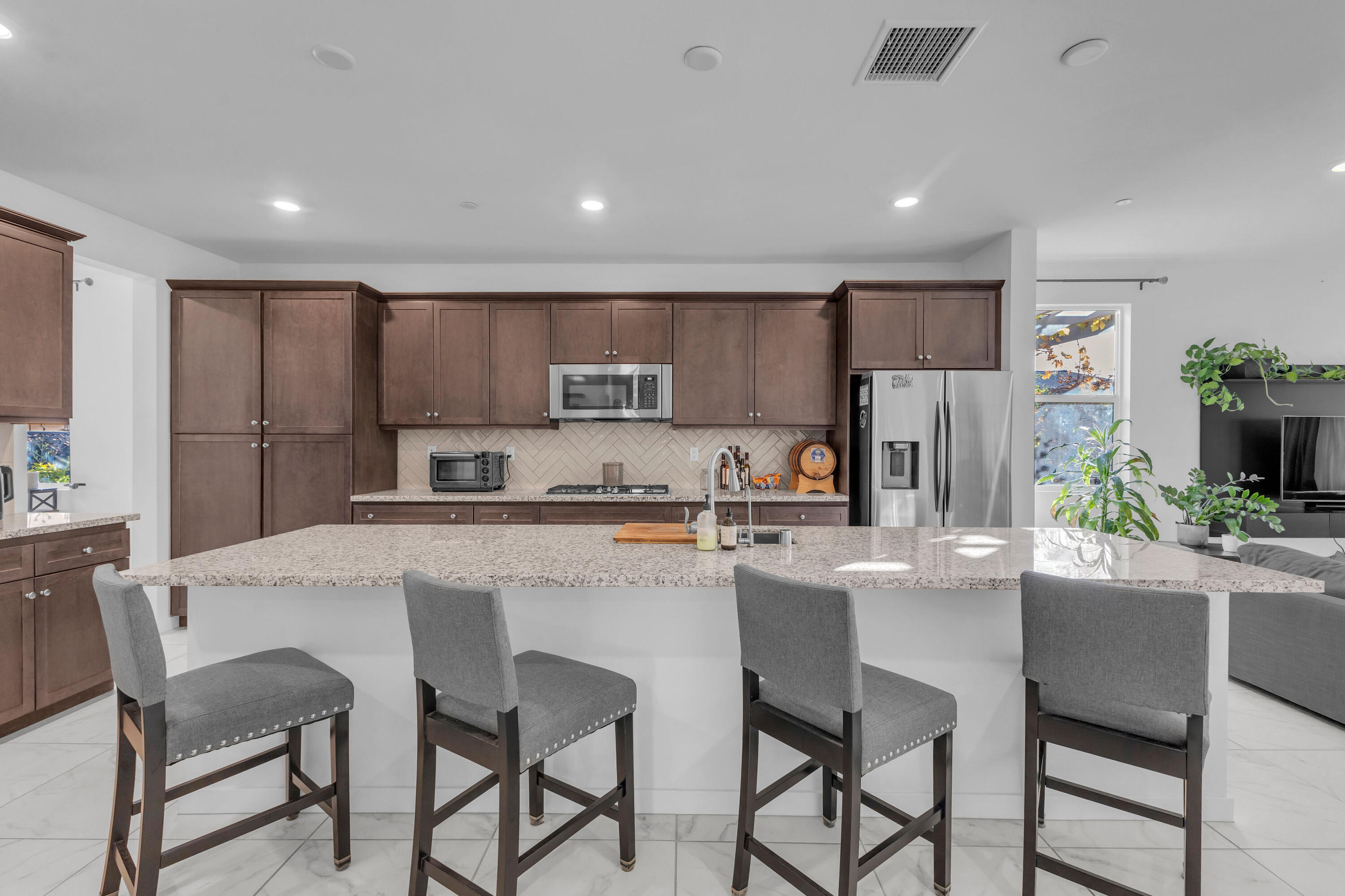 39763 Majorca Drive South Indio, CA 92203 - Photo 12 of 57 a kitchen with kitchen island a dining table and chairs