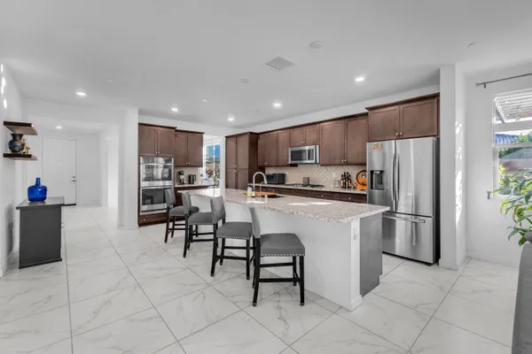 a kitchen with stainless steel appliances granite countertop a sink and a microwave
