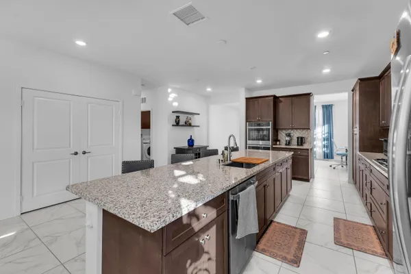 a kitchen with stainless steel appliances granite countertop a sink and stove