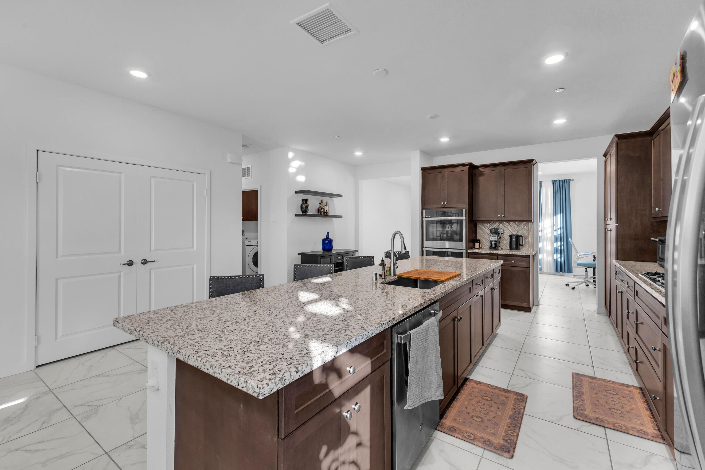 39763 Majorca Drive South Indio, CA 92203 - Photo 14 of 57 a kitchen with granite countertop kitchen island a sink appliances and a counter top space