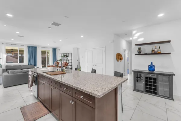 a kitchen with stainless steel appliances granite countertop a stove a microwave and a refrigerator