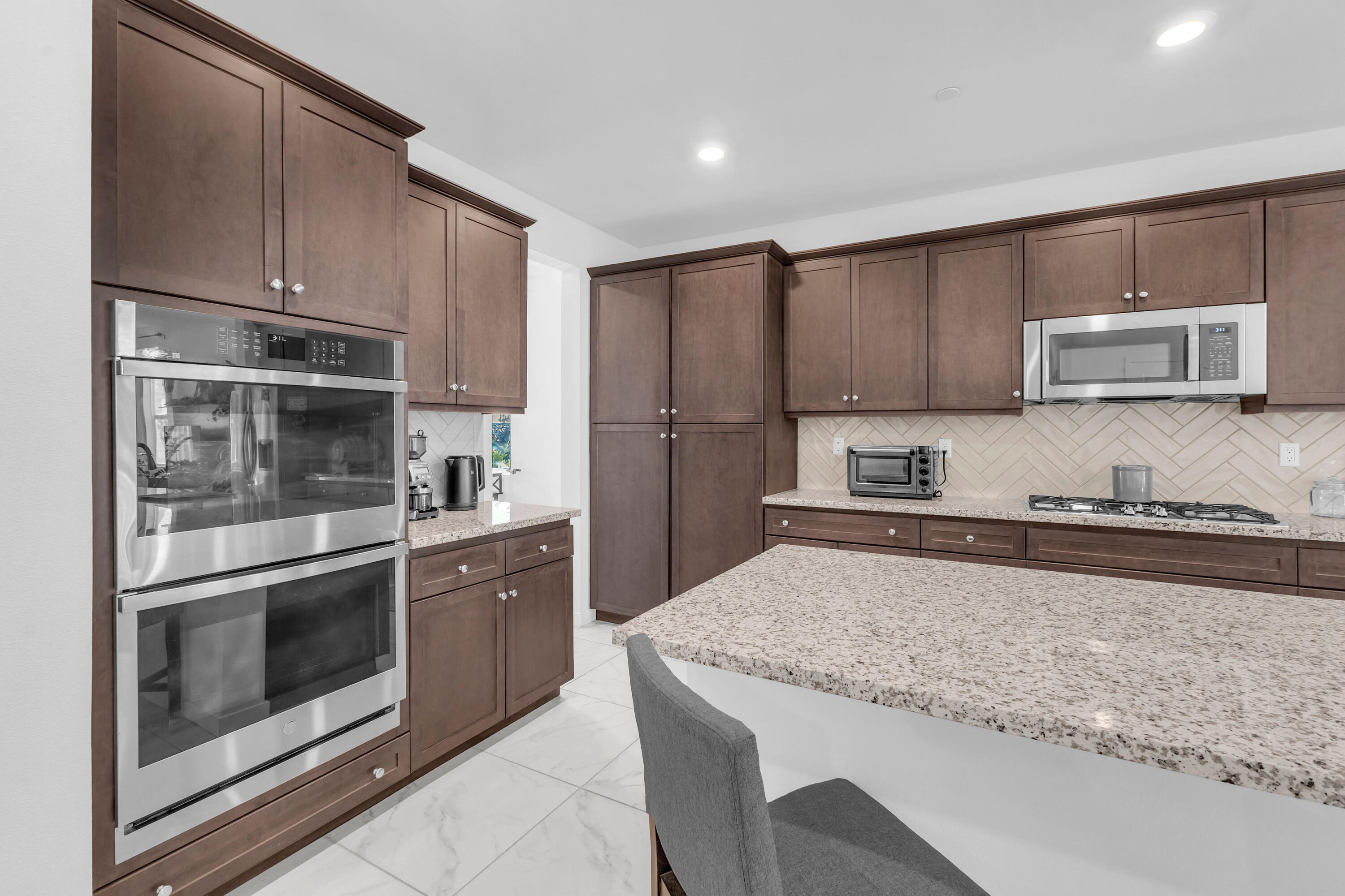 39763 Majorca Drive South Indio, CA 92203 - Photo 18 of 57 a kitchen with stainless steel appliances granite countertop a stove a microwave and a refrigerator