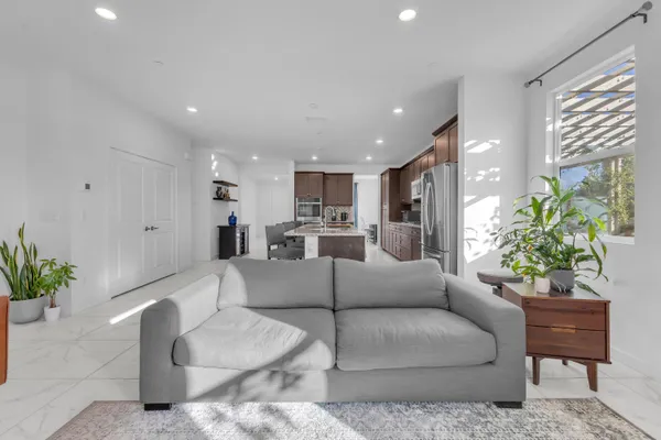 a large bed in a bedroom next to a window and a bathroom