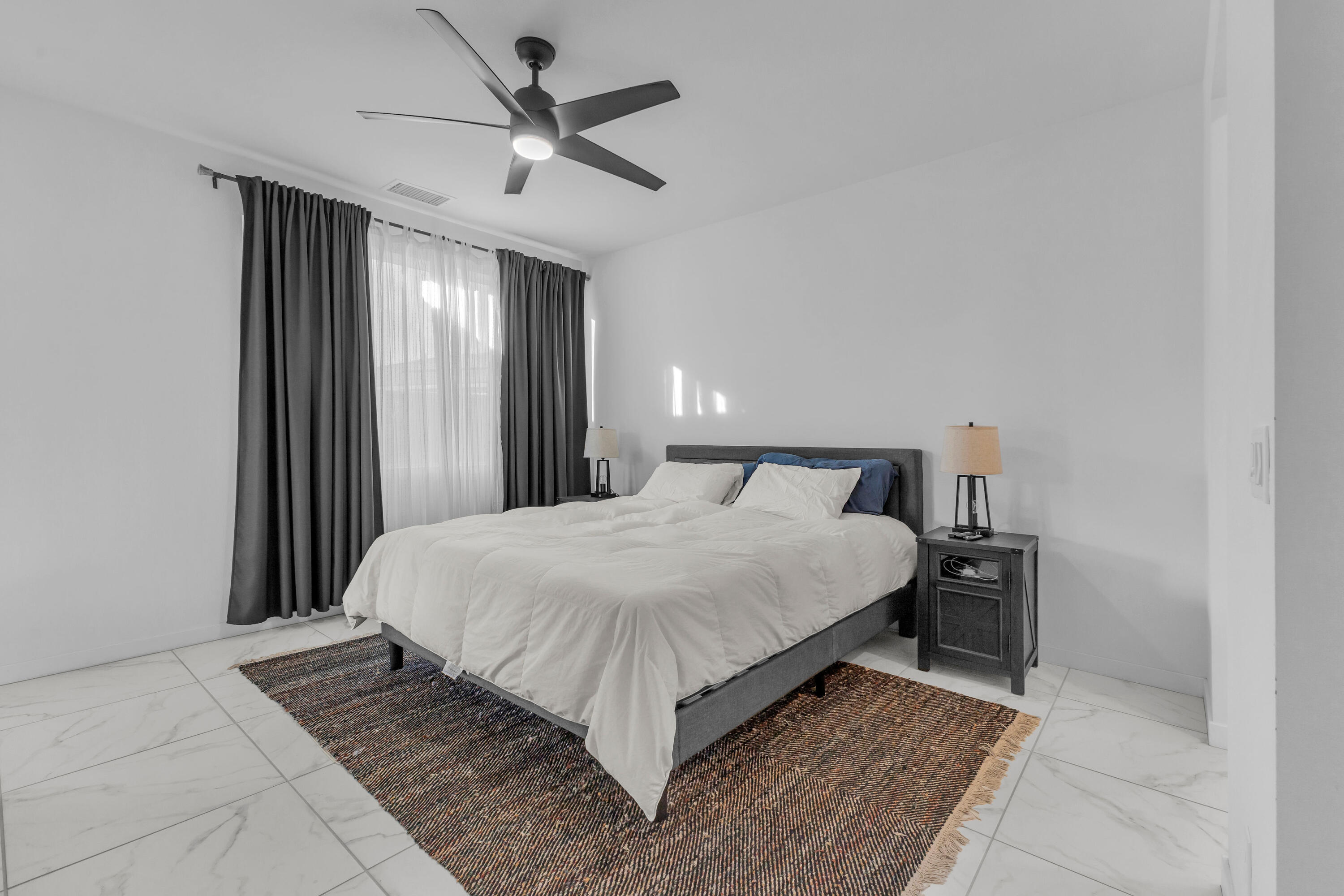 39763 Majorca Drive South Indio, CA 92203 - Photo 27 of 57 a bedroom with a large bed and a chandelier