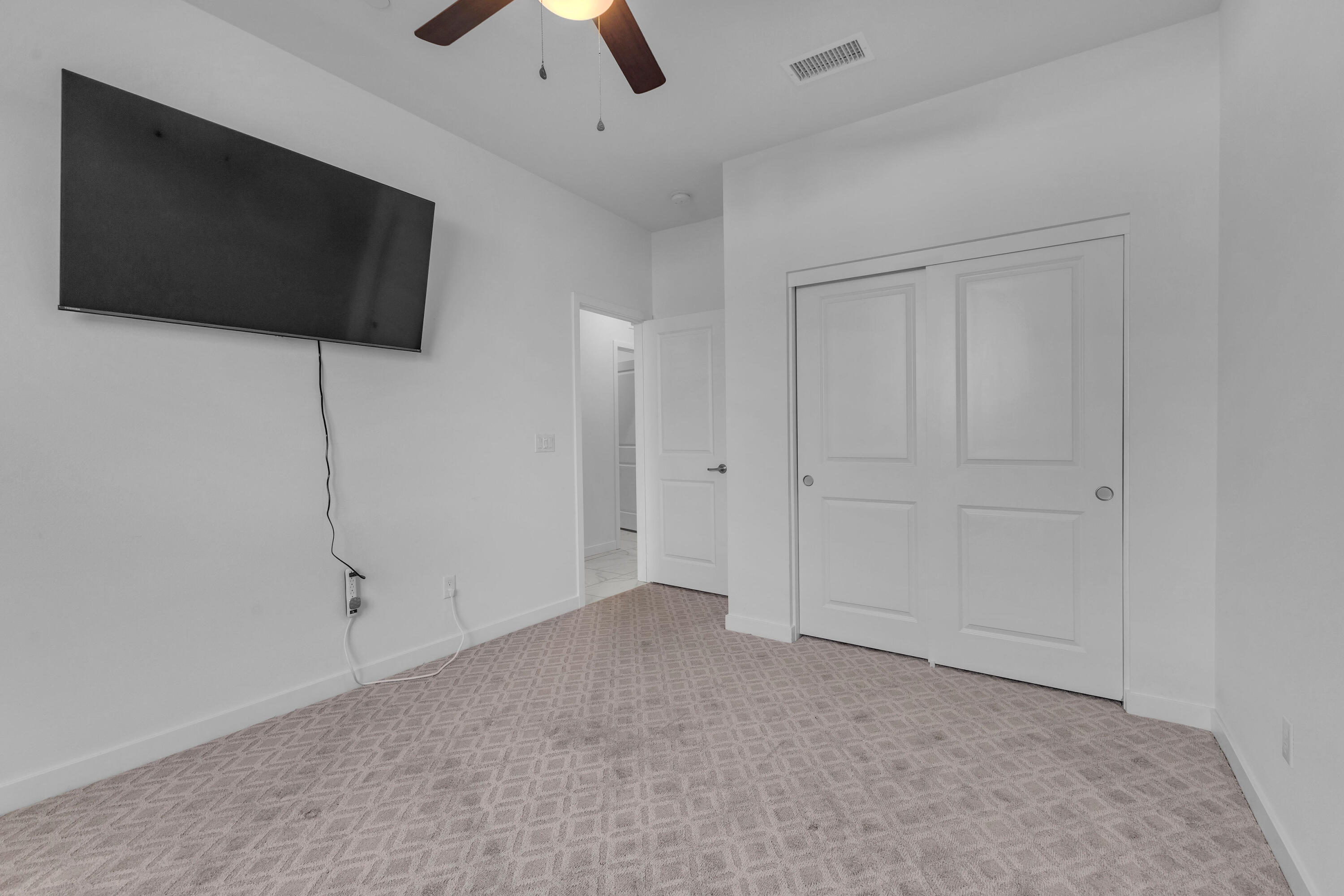 39763 Majorca Drive South Indio, CA 92203 - Photo 36 of 57 a view of an empty room with a ceiling fan and a window