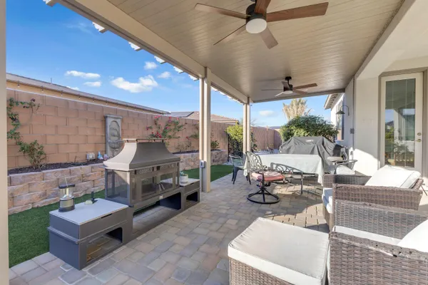 a view of a chairs and table in backyard