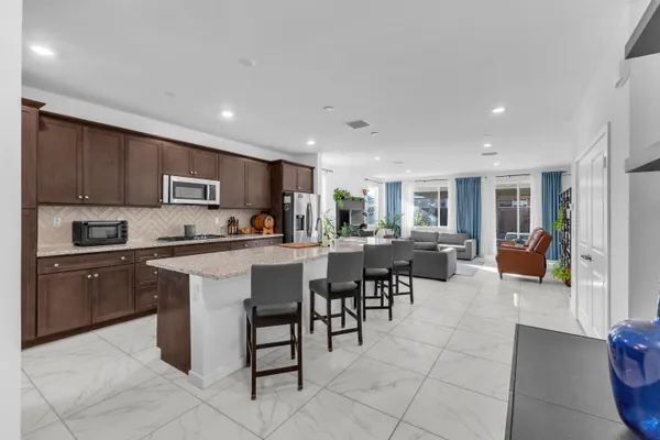 a view of kitchen with furniture and refrigerator