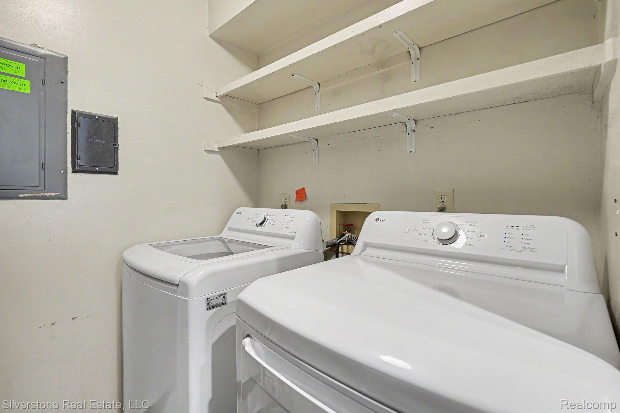 1502 Meadowside Drive Rochester, MI 48307 - Photo 23 of 27 Dedicated laundry area featuring a top-load washer and front-load dryer