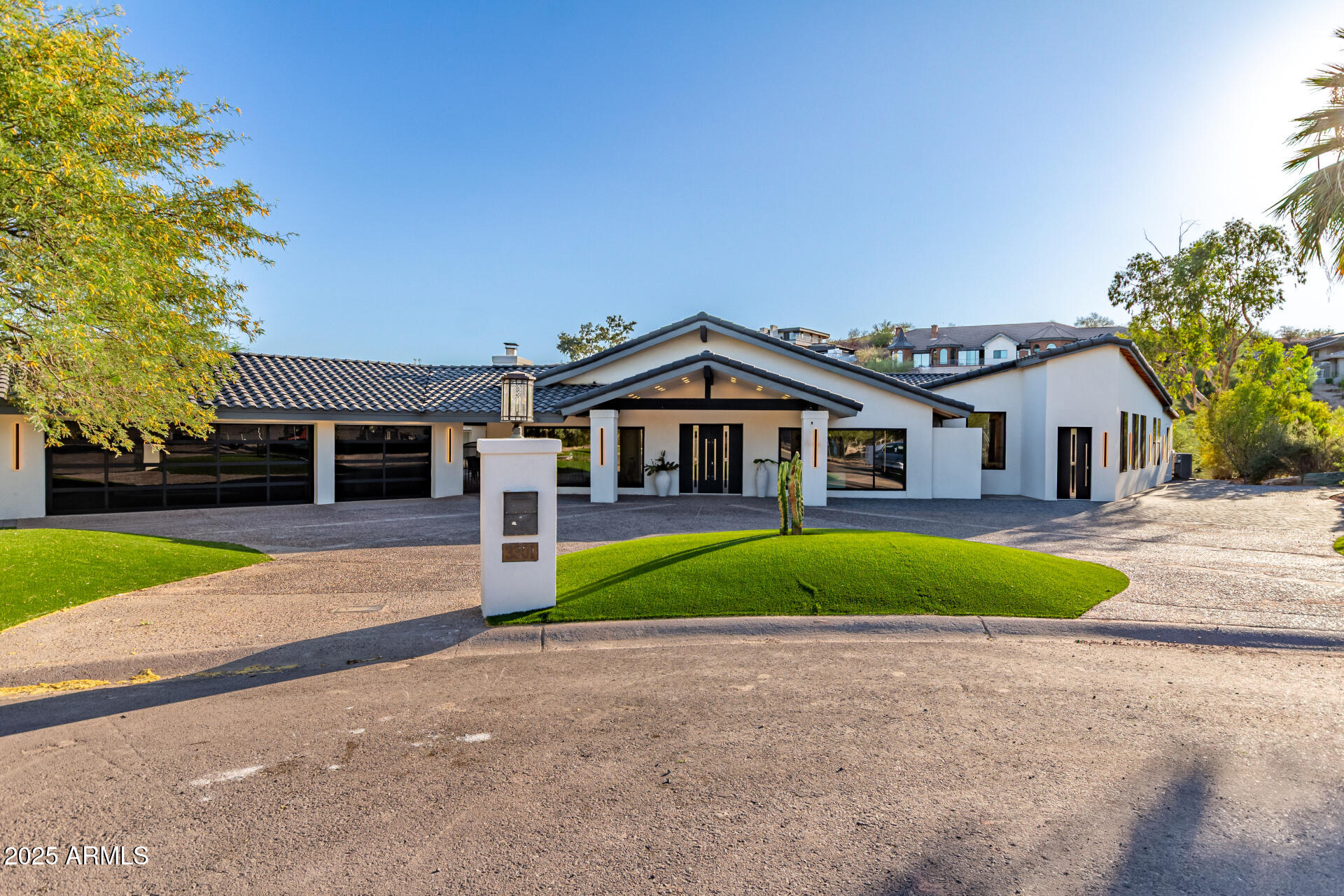 3301 East Rovey Avenue Paradise Valley, AZ 85253 - Photo 4 of 105 a front view of a house with a yard and garage