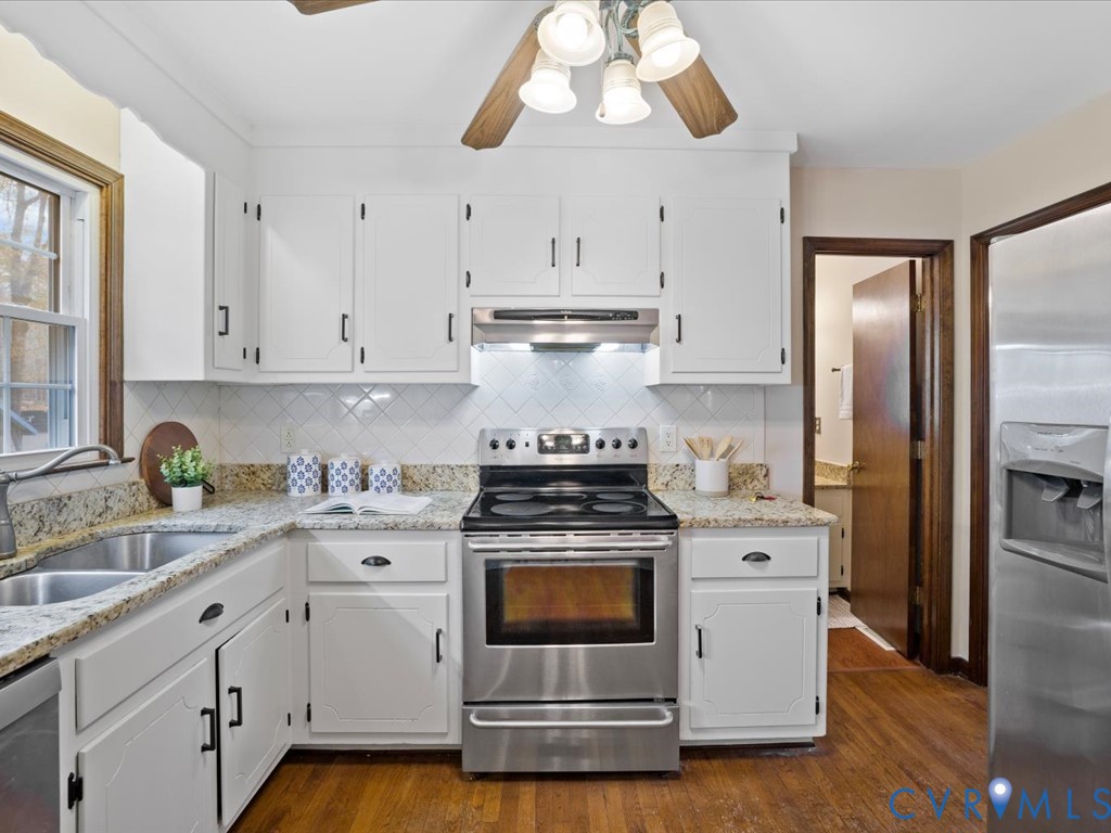 1145 Timber Trace Road Powhatan, VA 23139 - Photo 11 of 32 a kitchen with cabinets stainless steel appliances a sink and wooden floor