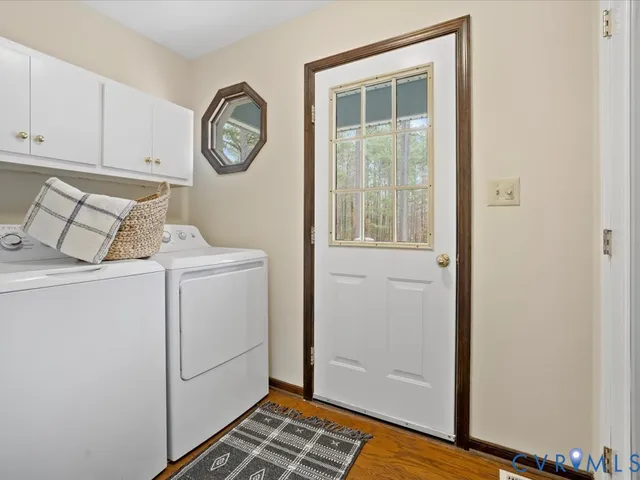 a view of washer and dryer with bathroom
