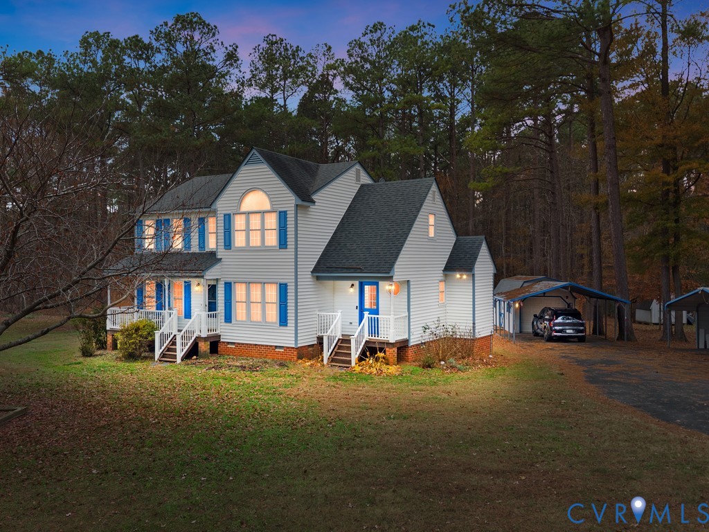 1145 Timber Trace Road Powhatan, VA 23139 - Photo 2 of 32 a front view of a house with a garden