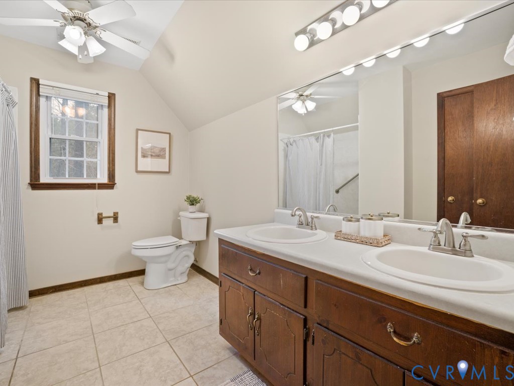 1145 Timber Trace Road Powhatan, VA 23139 - Photo 22 of 32 a spacious bathroom with a double vanity sink a mirror and a toilet