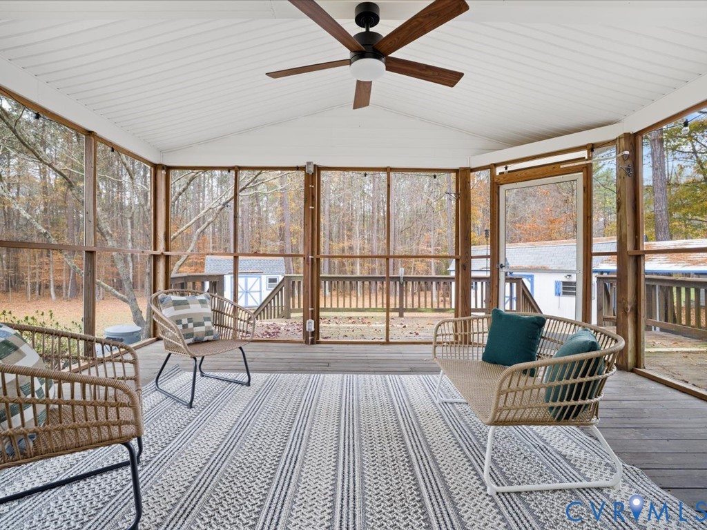 1145 Timber Trace Road Powhatan, VA 23139 - Photo 5 of 32 a living room with a balcony furniture and a floor to ceiling window