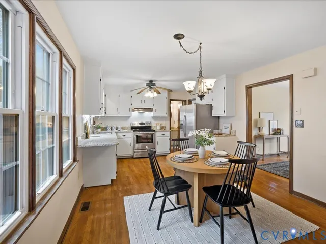 a view of a dining room with furniture window and wooden floor